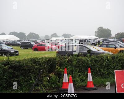 Headcorn, Kent, Regno Unito. 27 Giugno 2021. Regno Unito Meteo: Pioggia e maltempo hanno chiuso la Battle of Britain Air Show presto di Domenica con il clou del giorno 9 Spitfires e le frecce rosse annullati a causa della bassa nuvola e scarsa visibilità. Non è stato effettuato alcun volo tutto il giorno a causa della base cloud troppo bassa. I visitatori vedevano tornare alle loro auto con gli ombrelloni. Credit: James Bell/Alamy Live News Foto Stock