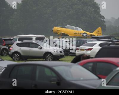 Headcorn, Kent, Regno Unito. 27 Giugno 2021. Regno Unito Meteo: Pioggia e maltempo hanno chiuso la Battle of Britain Air Show presto di Domenica con il clou del giorno 9 Spitfires e le frecce rosse annullati a causa della bassa nuvola e scarsa visibilità. Non è stato effettuato alcun volo tutto il giorno a causa della base cloud troppo bassa. I visitatori vedevano tornare alle loro auto con gli ombrelloni. Credit: James Bell/Alamy Live News Foto Stock