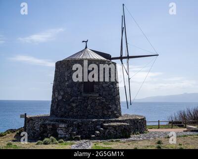 Mulino a vento di roccia vulcanica sul mare a Corvo Island, Azzorre Foto Stock