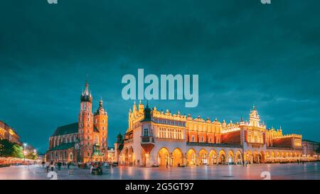 Cracovia in Polonia. Sera vista notturna di Santa Maria la Basilica e il panno Hall edificio. Famoso punto di riferimento vecchia chiesa della Madonna Assunta in Cielo. UNESCO Foto Stock