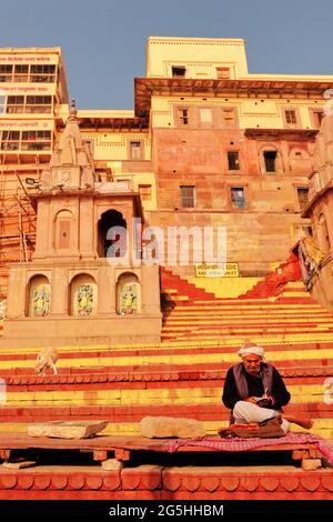 Varanasi, India - 03 febbraio 2021: Un sadhu (monaco) seduto sul Ghat nel ghat Ganga di giorno, a Varanasi, India. Foto Stock