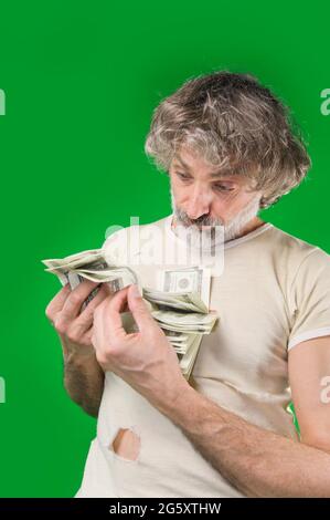 Uomo maturo con molti dollari, ansioso Foto Stock