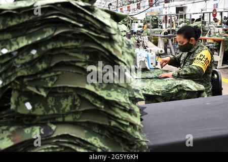 CITTÀ DEL MESSICO, MESSICO - GIUGNO 15: Un militare produce uniformi per i membri dell'esercito messicano presso la fabbrica di abbigliamento e attrezzature militari fondata a 1951. I lavoratori militari producono più di 3,000 uniformi al giorno, fabbricate con tessuto da loro fatto per uso esclusivo per l'esercito messicano. Il 15 giugno 2021 a Città del Messico, Messico. Credit: Carlos Tischler/Eyepix Group/The Photo Access Foto Stock