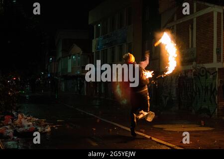 Bogotà, Colombia. 28 Giugno 2021. Un dimostratore lancia una bomba molotov alla polizia mentre le proteste anti-governative si scatenano in scontri tra dimostranti e la polizia malata della Colombia (ESMAD), tra tensioni politiche contro il governo del presidente Ivan Duque, casi di brutalità della polizia e disuguaglianze, mentre la Colombia segna un secondo mese di proteste anti-governative, a Bogotà, Colombia il 28 giugno 2021. Credit: Long Visual Press/Alamy Live News Foto Stock