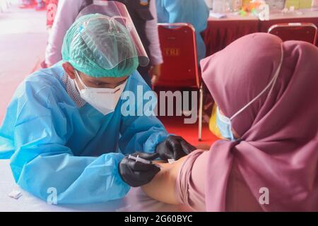 Indonesia. 01 luglio 2021. Una donna riceve un vaccino contro il Sinovac COVID-19 durante una vaccinazione di massa allo stadio Patriot Candrabaga di Bekasi, Jawa Barat, Indonesia, giovedì, luglio 1, 2021. Il quarto paese al mondo più popoloso, ha visto l'aumento delle infezioni da COVID-19 nelle ultime settimane, esercitando pressioni sugli ospedali, anche nella capitale, dove la maggior parte dei letti ospedalieri sono pieni. (Foto di Ahmad Soleh/Sipa USA) Credit: Sipa USA/Alamy Live News Foto Stock