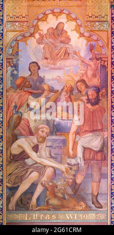 VIENNA, AUSTIRA - JUNI 24, 2021: L'affresco della parabola del ricco e Lazzaro nella chiesa di Votivkirche dei fratelli Carl e Franz Jobst Foto Stock