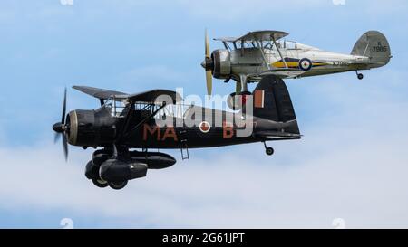 Westland Lysander & Gloster Gladiator volare in formazione al Shuttleworth Flying Festival of Britain Airshow il 6 giugno 2021 Foto Stock