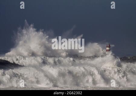 Onde tempestose splash. Povoa de Varzim e di Vila do Conde porto entrata nord del Portogallo. Foto Stock