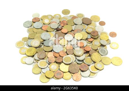 Monete di paesi diversi e denominazioni diverse su sfondo bianco. Primo piano monete europee e americane di paesi diversi. Backgroun Foto Stock