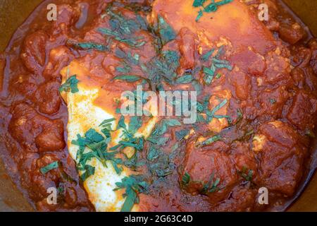 Shakshouka - piatto maghrebi con uova in camicia in salsa di pomodoro Foto Stock