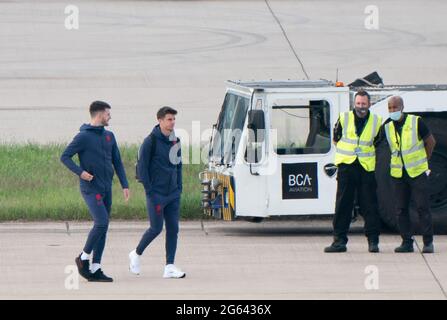 L'Inghilterra Declan Rice (a sinistra) e Mason Mount sul asfalto in arrivo a bordo dell'aereo mentre il team inglese partirà dall'aeroporto di Birmingham, in direzione di Roma, dove domani (sabato 3 luglio) si troveranno ad affrontare l'Ucraina nel quarto finale dell'Euro 2020. Data immagine: Venerdì 2 luglio 2021. Foto Stock