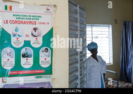 SENEGAL, Kaolack, Medina Sabakh, vilage Taiif, centro sanitario rurale, Pandemia di corona, infermiera e consapevolezza del virus di corona tabellone / Dorf Taif, ländliche Gesundheitsstation, Krankenschwester und Plakat zur Corona Virus Aufklärung Foto Stock