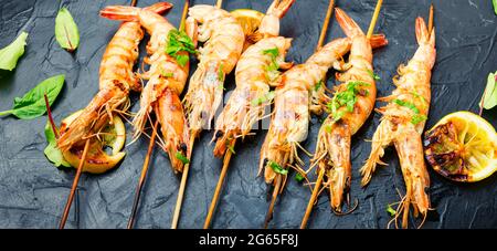 Scampi fritti, gamberi arrostiti su uno spiedino. Spiedini di gamberi grigliati Foto Stock