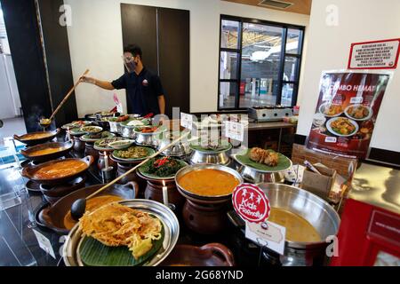 Una Waitress che indossa una maschera protettiva in un ristorante in un centro commerciale a Bogor, Giava Occidentale, Indonesia durante l'epidemia di Covid-19, il 3 luglio 2021. (Foto di Adriana/INA Photo Agency/Sipa USA) Foto Stock