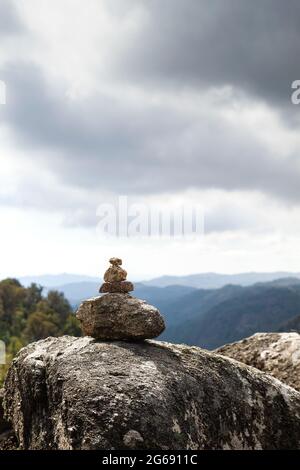 Cairn o marcatore di pietra in sentiero di montagna Foto Stock