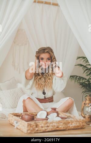 La giovane donna ama bere caffè e cocco. Donna che si rilassa in un hotel tropicale Foto Stock