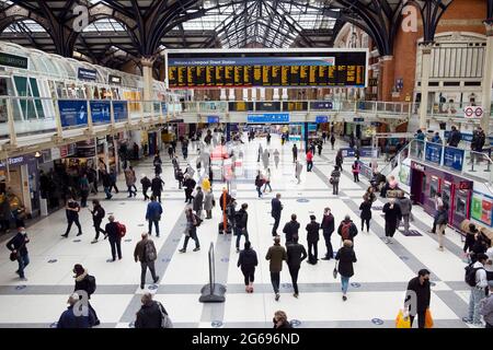 Persone passeggeri che camminano sull'atrio e controllano gli orari di partenza alla stazione di Liverpool Street durante la pandemia di Covid a Londra UK KATHY DEWITT Foto Stock