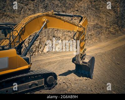 Escavatore pesante giallo in cantiere Foto Stock