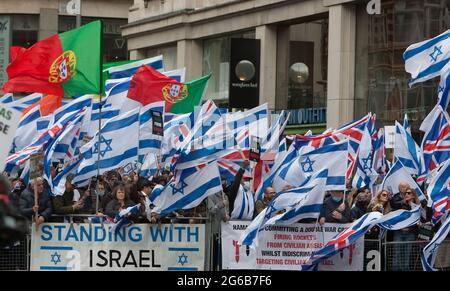 Londra, Regno Unito. 23 maggio 2021. I sostenitori di pro-Israele fanno onda le bandiere, tengono i cartelli durante la protesta.i dimostranti pro-israeliani si radunano fuori dall'ambasciata israeliana ad High Street Kensington a sostegno del cessate il fuoco concordato il 21 maggio. Un piccolo gruppo di palestinesi si è rivolto contro dimostrare la manifestazione israeliana, tuttavia la polizia ha formato un cordone tra le due folle per evitare qualsiasi violenza. Credit: Martin Pope/SOPA Images/ZUMA Wire/Alamy Live News Foto Stock