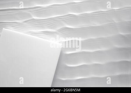 Podio vuoto quadrato bianco su fondo trasparente chiaro d'acqua Foto Stock