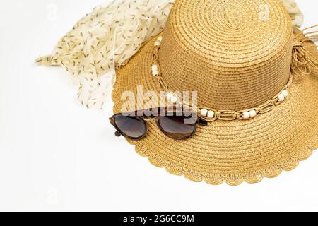 Accessorio estivo - cappello di paglia, occhiali da sole e sciarpa su sfondo bianco Foto Stock