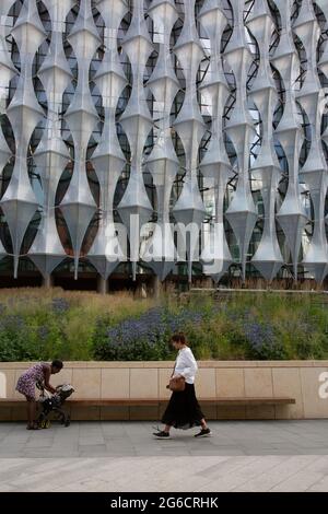 Due donne che camminano oltre la nuova Ambasciata americana progettata dagli architetti KieranTimberlake. Londra, Regno Unito. Foto Stock