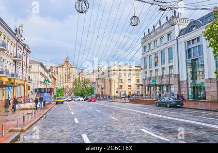 KIEV, UCRAINA - 18 MAGGIO 2021: Viale Bohdan Khmelnytsky nella città vecchia con una vista del famoso edificio in stile stalinista Druzhba, sormontato da stelle e l Foto Stock