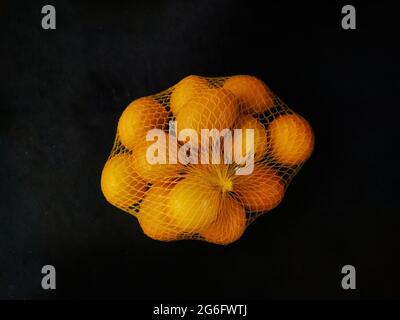 Limoni. Limoni nella rete. Limone al greengrocrocer stalla. Foto Stock