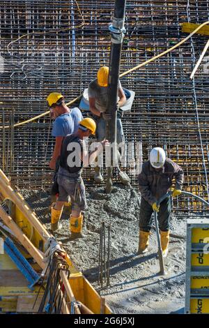 Wien, Vienna: Lavori di calcestruzzo in cantiere, lavoro, installazione di calcestruzzo preconfezionato con una pompa per calcestruzzo nel 22. Donaustadt, Wien, Austriaci Foto Stock