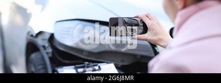 Agente di assicurazione che scatta le foto della closeup di automobile relitto Foto Stock