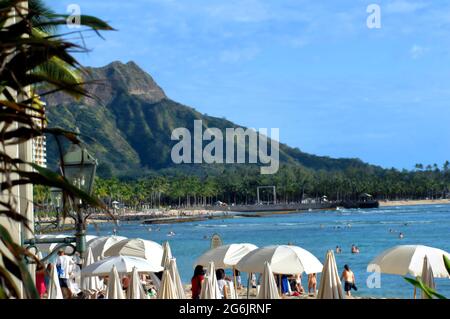 Hotel e ombrelloni incorniciano Diamond Head e Waikiki Beach. Affollato di bagnanti, bagnanti e osservatori. Foto Stock