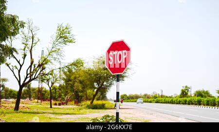 07 luglio 2021 - Reengus, Sikar, India. Cartello con la scritta "STOP" con attraente sfondo rosso e linguaggio scritto bianco. Segnaletica stradale e simbolo conce Foto Stock