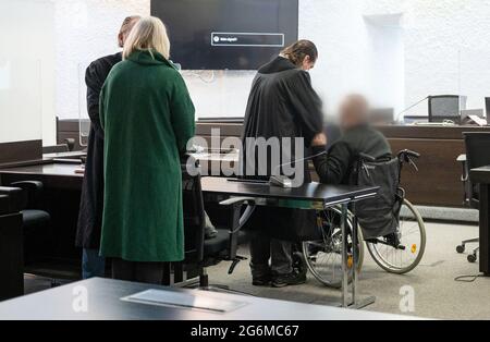 Stoccarda, Germania. 07 luglio 2021. Un imputato in un processo sulla tratta di esseri umani siede in una sala di giustizia presso il Tribunale regionale di Stoccarda, con il suo collega in piedi dietro di lui. I due imputati usavano i lavoratori polacchi in condizioni inaccettabili nella loro azienda agricola di Grafenau (distretto di Böblingen) tra il dicembre 2008 e il luglio 2011. (Imputato pixelated per motivi legali) credito: Marijan Murat/dpa/Alamy Live News Foto Stock