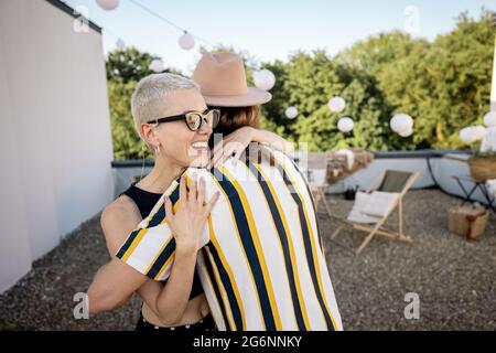 I giovani amici alla moda saluta alla festa all'aperto Foto Stock