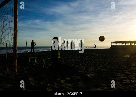 San Salvador, El Salvador. 07 luglio 2021. La gente gioca a calcio alla spiaggia di San Marcelino al tramonto. Credit: SOPA Images Limited/Alamy Live News Foto Stock