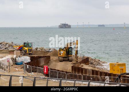 07-07-2021 Portsmouth, Hampshire, UK un escavatore e un mugnatore che lavorano sulle difese costiere a Southsea a Portsmouth con il mare sullo sfondo Foto Stock