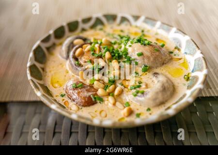 Champignons flambé, con brandy, crema, olio di tartufo, servito su un piatto in ristorante, sotto luce naturale Foto Stock