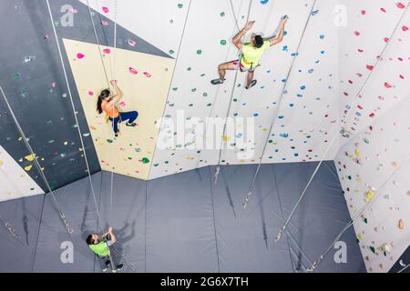 Vista in alto di una gente atletica che pratica roccia parete arrampicata Foto Stock