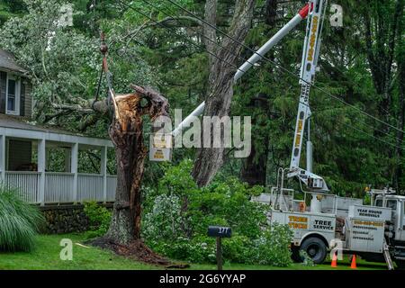 Milford, Stati Uniti. 09 luglio 2021. Un lavoratore rimuove un albero che è caduto su una casa a Milford dopo una forte tempesta causata dalla tempesta tropicale Elsa ha colpito la zona. Danni da tempesta tropicale Elsa colpire gli stati medio-atlantici Giovedi notte e Venerdì mattina. Credit: SOPA Images Limited/Alamy Live News Foto Stock