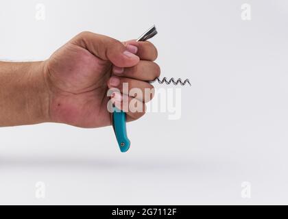 Persona che tiene un cavatappi isolato su uno sfondo bianco Foto Stock