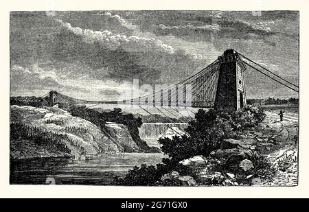 Una vecchia incisione del Niagara Clifton Bridge c. 1870. È tratto da un libro vittoriano del 1890 sulle scoperte e le invenzioni del 1800. Il Niagara Clifton Bridge (o il primo ‘Falls View Suspension Bridge’) era un ponte sospeso sul fiume Niagara tra le Cascate del Niagara, New York, USA e Clifton, Ontario, Canada. È stato progettato da Samuel Keefer, con la costruzione a partire dal 1867. La sua estensione di oltre 1200 metri era la più lunga del mondo al tempo. Fu ufficialmente aperto al traffico nel 1869 e fu distrutto in una tempesta nel 1889. Foto Stock