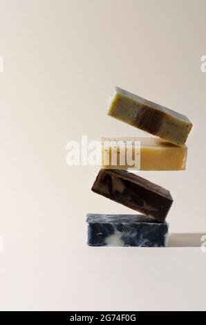 Saponetta equilibrante da prodotti naturali di diversi colori su sfondo beige Foto Stock