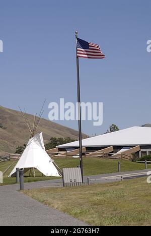 SPALDING / IDAHO STATE/ USA . Bandiera degli Stati Uniti e Tepe Indiano al Nez Perce Musuem, il sito di Spalding, situato lungo l'autostrada US 95 fino alla sede del Nez Perce National Historical Park, Un moderno centro visitatori offre una bella collezione di film museo sulla storia del popolo Nez Perce e un piccolo negozio di articoli da regalo. Il sito di 99 ettari contiene cimiteri storici e l'edificio, cartelli interpretativi e grande area picnic, l'attuale communit e parco di spalding ufficiale chiamato nel 1897 è stato Originariamente chiamato Lapwai e servito come homesite tradizionale per oltre 11.000 anni al thlep-thlep weyma band Foto Stock