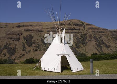 SPALDING / IDAHO STATE/ USA . Bandiera degli Stati Uniti e Tepe Indiano al Nez Perce Musuem, il sito di Spalding, situato lungo l'autostrada US 95 fino alla sede del Nez Perce National Historical Park, Un moderno centro visitatori offre una bella collezione di film museo sulla storia del popolo Nez Perce e un piccolo negozio di articoli da regalo. Il sito di 99 ettari contiene cimiteri storici e l'edificio, cartelli interpretativi e grande area picnic, l'attuale communit e parco di spalding ufficiale chiamato nel 1897 è stato Originariamente chiamato Lapwai e servito come homesite tradizionale per oltre 11.000 anni al thlep-thlep weyma band Foto Stock