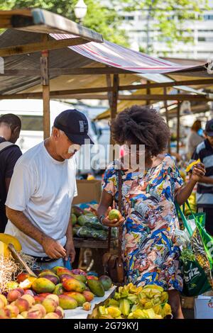 Una donna brasiliana e un venditore di strada al mercato locale di Rio de Janeiro. Foto con Leica M10 Foto Stock