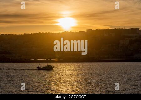 Vista sul porto di Algeri al tramonto. Tempo calmo. Vista dall'imbarcazione. Piccola barca da pesca. Foto Stock