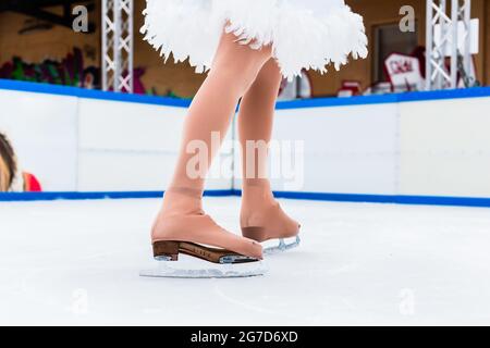 Sezione bassa di un pattinatore di ghiaccio femminile su ghiaccio rink Foto Stock