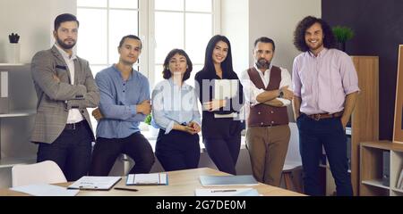 Un team di professionisti in grado di organizzare ritratti in una sala riunioni d'ufficio Foto Stock