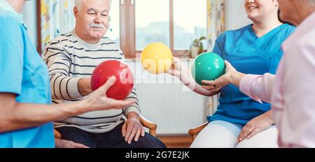 Gruppo di anziani di fare lo sport e la ginnastica con sfere in pensionati home Foto Stock