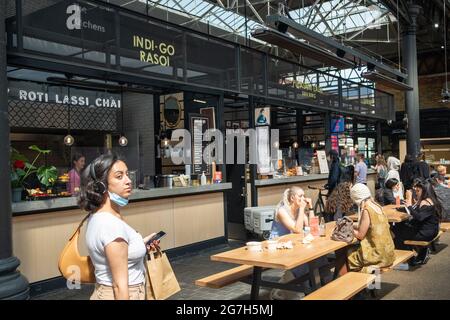 Londra - Luglio 2021: Bancarelle di cibo all'interno del mercato di Spitalfields. Un mercato popolare con cibo, bar, arte e artigianato Foto Stock